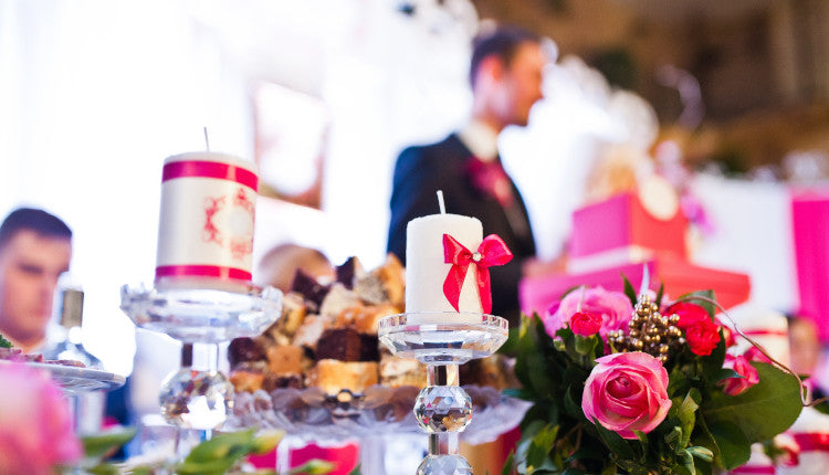 Elegant table setting with candles and flowers, perfect for Weddings at [Your Store Name]. Celebrate with style!